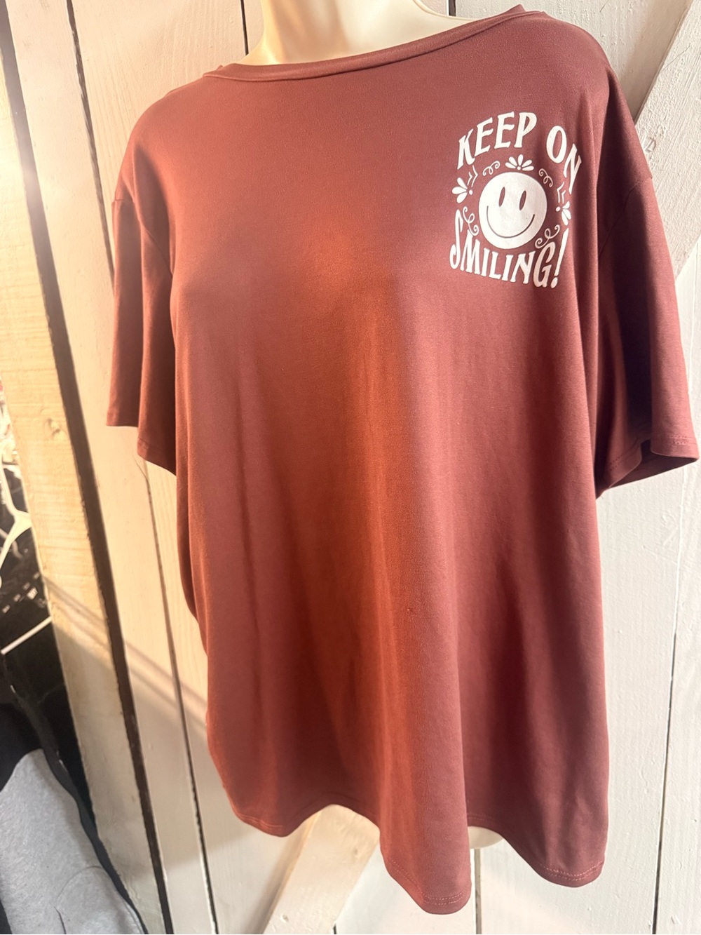 Rust color Smiley Graphic Short Sleeve Tee with beautiful uplifting back.